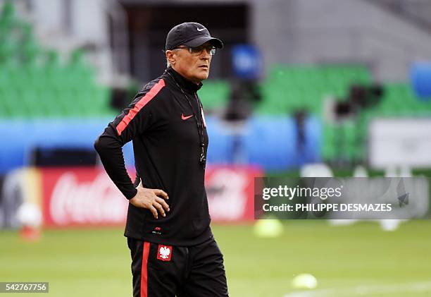 Poland's head coach Adam Nawalka takes part in a training session at the Geoffroy-Guichard stadium in Saint-Etienne on June 24 on the eve of their...