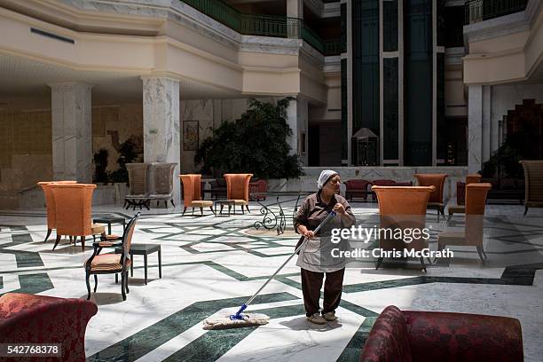 An employee mops the lobby floor at the closed Imperial Marhaba Hotel on June 24, 2016 in Sousse, Tunisia. The Imperial Marhaba hotel was the main...