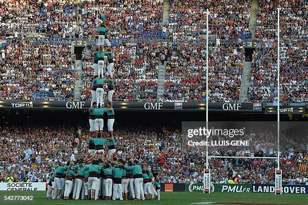 People build a Casteller before the French Top14 rugby union final match Toulon vs Racing 92 at the Camp Nou stadium in Barcelona on June 24, 2016. /...