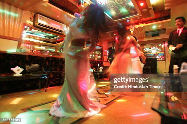 Bar girls performing dance at a bar on August 9, 2005 in Mumbai, India.