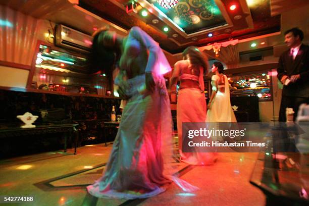 Bar girls performing dance at a bar on August 9, 2005 in Mumbai, India.