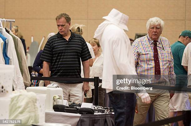 Guests look at items belonging to notorious Boston mobster James "Whitey" Bulger are displayed during before an asset-forfeiture auction in Boston,...