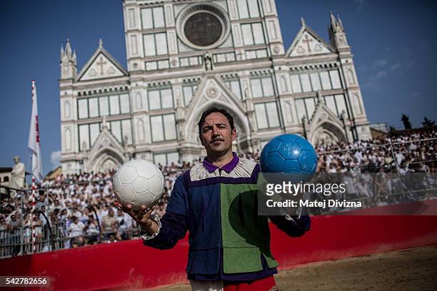 Man in traditional dress holds balls before the final match of The Calcio Storico Fiorentino between the Santo Spirito Bianchi Team and the La Santa...