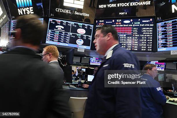 Traders work on the floor of the New York Stock Exchange following news that the United Kingdom has voted to leave the European Union on June 24,...