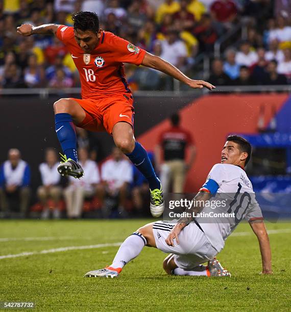 James Rodriguez of Colombia figths for the ball with Gonzalo Jara of Chile during a Semifinal match between Colombia and Chile at Soldier Field as...