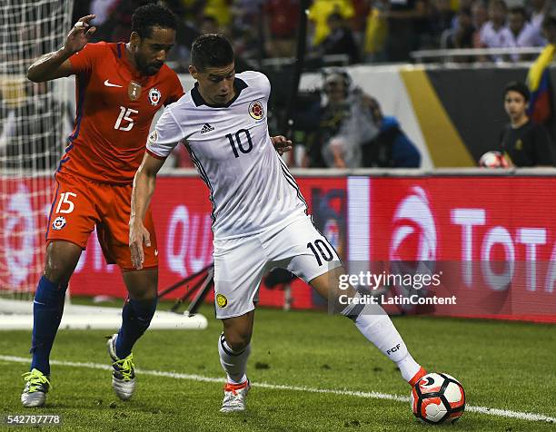 James Rodriguez of Colombia and Jean Beausejour of Chile fight for the ball during a Semifinal match between Colombia and Chile at Soldier Field as...