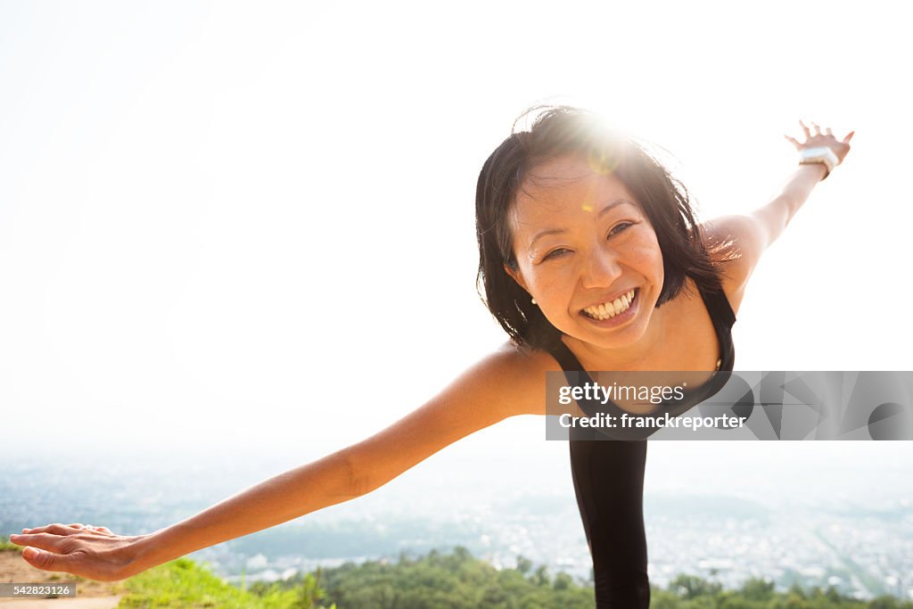 Japanese woman doing yoga outdoors