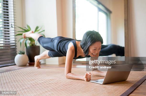 asian woman exercising at home - grand prix of japan practice stockfoto's en -beelden