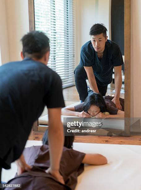 chiropractor adjusting his patient's back - body massage japan stock pictures, royalty-free photos & images