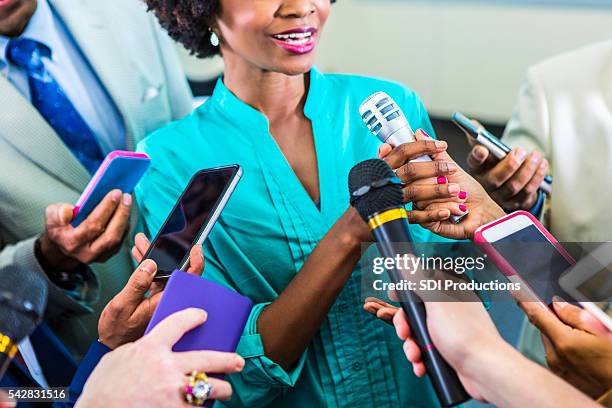 happy woman speaks to media - phone interview event stock pictures, royalty-free photos & images