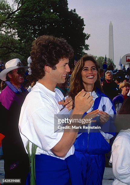 Married American actors Kirk Cameron and Chelsea Noble share a laugh during the Great American Workout event on the South Lawn of the White House,...