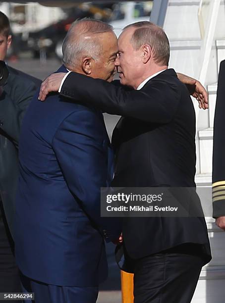 Russian President Vladimir Putin embrasses Uzbek President Islam Karimov during his departure after the Shanghai Cooperation Organisation Summit in...