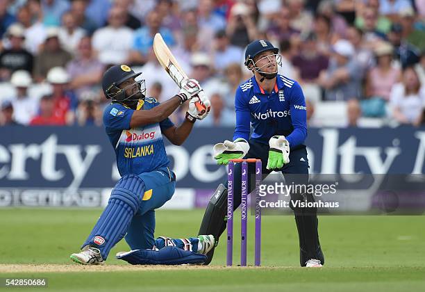 Seekkuge Prasanna of Sri Lanka batting as Jos Buttler of England looks on during the 1st Royal London ODI between England and Sri Lanka at Trent...