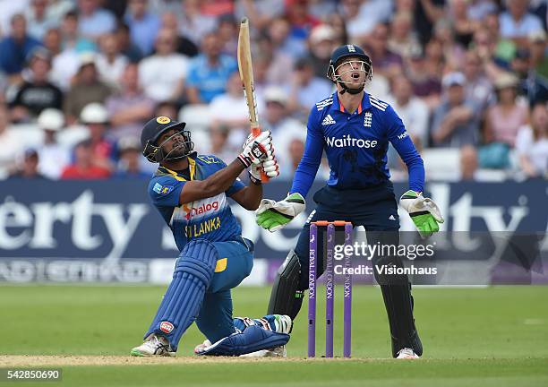 Seekkuge Prasanna of Sri Lanka batting as England's Jos Buttler looks on during the 1st Royal London ODI between England and Sri Lanka at Trent...