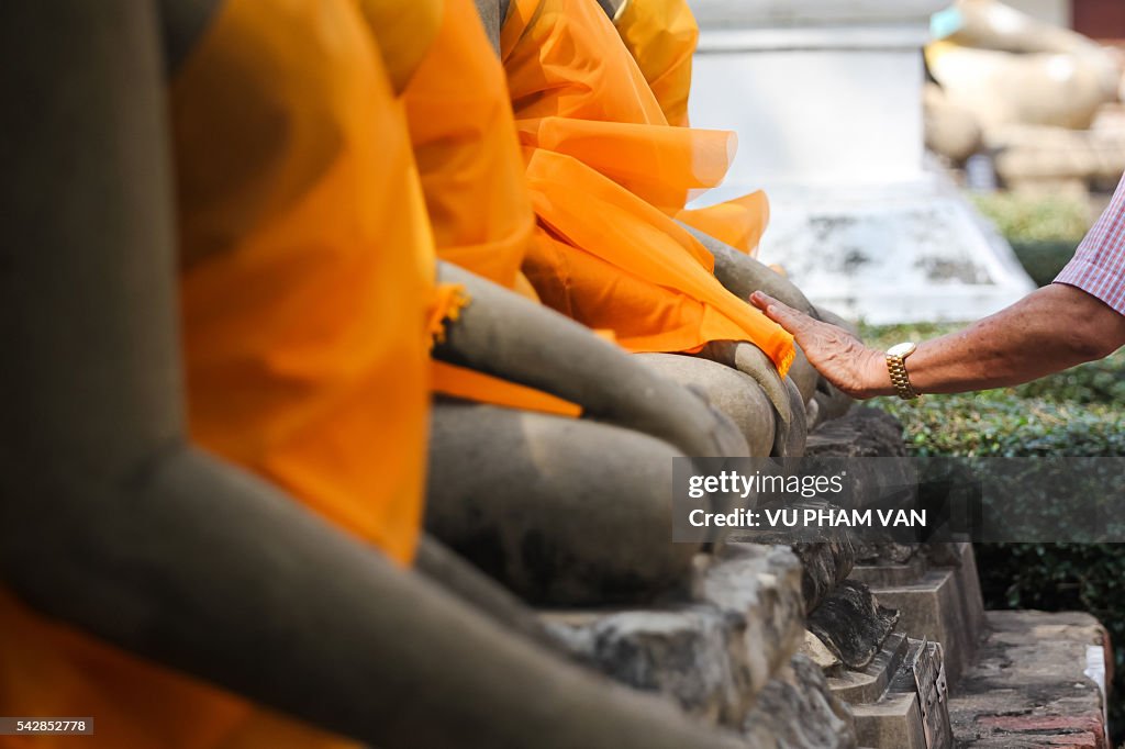 Touching hands of Buddha statues in Ayutthaya