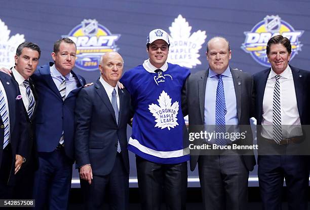 Auston Matthews celebrates onstage with the Toronto Maple Leafs after being selected first overall by the Toronto Maple Leafs during round one of the...