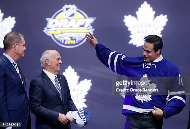 Auston Matthews celebrates onstage with Toronto Maple Leafs General Manager Lou Lamoriello after being selected first overall during round one of the...