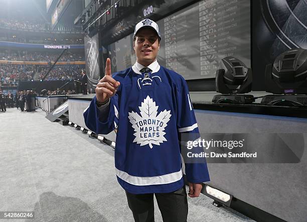 Auston Matthews holds up his right index finger after being selected first overall by the Toronto Maple Leafs in the 2016 NHL Draft at First Niagara...