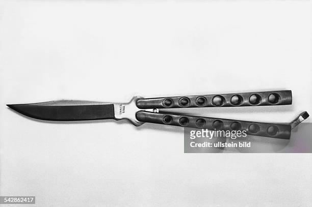 Butterflymesser mit gewellter Klinge. Jugendkriminalität; Klappmesser; Messer; Stichwaffe; Taschenmesser