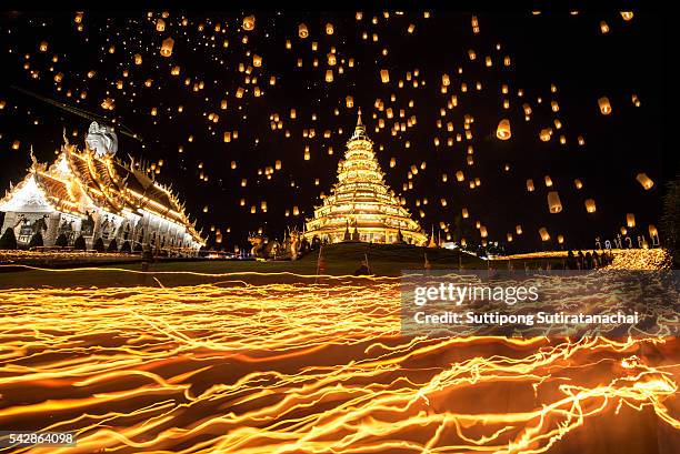 walking with lighted candles in hand around a temple candles light trail and paper lantern of yeepeng festival of pagoda at hyua pla kang temple on visakha buja day thailand - buddha purnima stock pictures, royalty-free photos & images