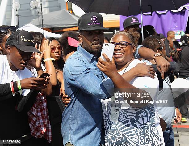 Host Ray J poses with a music fan during 106 & Park sponsored by Apple Music during the 2016 BET Experience at Microsoft Square on June 24, 2016 in...