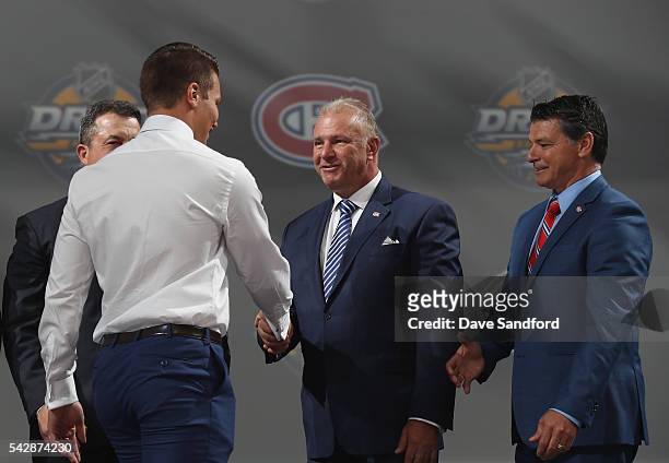 Mikhail Sergachev greets head coach Michel Therrien after being selected ninth overall by the Montreal Canadiens during round one of the 2016 NHL...