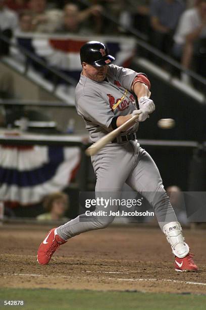 Mark McGwire of the St. Louis Cardinals swings at a pitch during game one of the National League West Divisional Series against the Arizona...