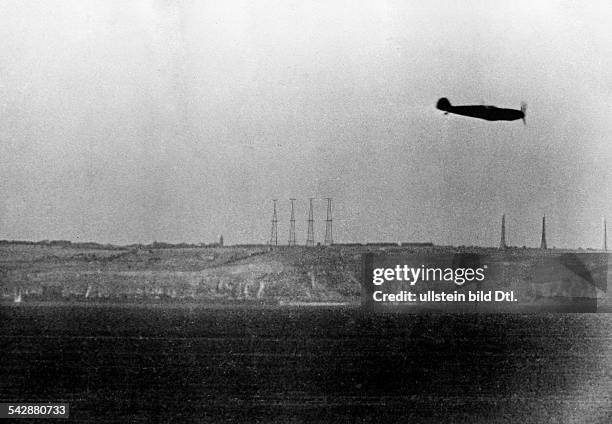 Air War: Battle of Britain - German fighter plane Me 109 in front of english coast with towers of radar units - october 1940