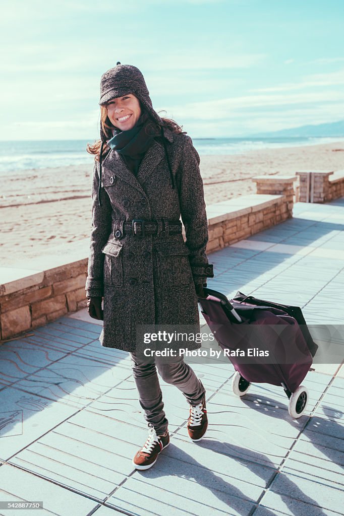 Pretty woman with shopping trolley bag