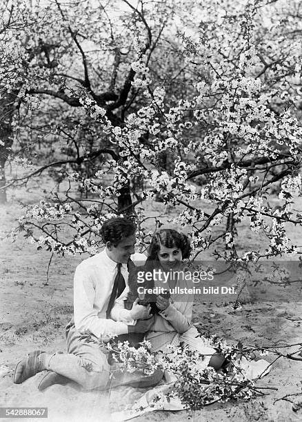 Jenny Jugo and Enrico Benfer under a cherry tree with blossoms. Brandenburg, Werder 1931