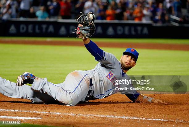 James Loney of the New York Mets reacts after making a play to tag first base after Jace Peterson of the Atlanta Braves struck out swinging to end...
