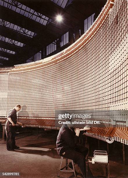 Germany; Berlin: dynamo factory by Siemens; men at work at a generator - 1960