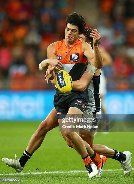 Matthew Kennedy of the Giants is tackled during the round 14 AFL match between the Greater Western Sydney Giants and the Carlton Blues at Spotless...