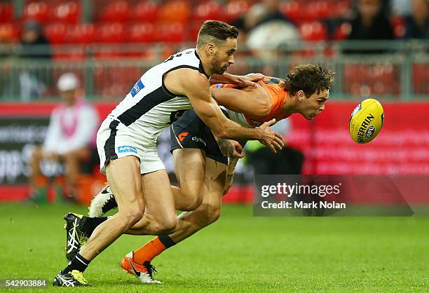 Andrew Walker of Carlton and Phil Davis of the Giants Nathan Wilson of the Giants contest for possession during the round 14 AFL match between the...