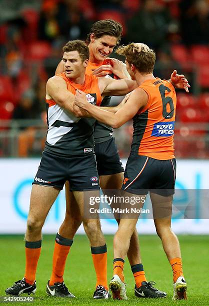 Lachie Whitfield of the Giants celebrates a goal with team mates during the round 14 AFL match between the Greater Western Sydney Giants and the...