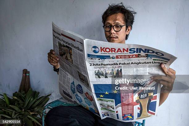 Man reads the Indonesian newspaper KORAN SINDO which shows the cover headline which reads 'British looked at new era', on June 25, 2016 in...