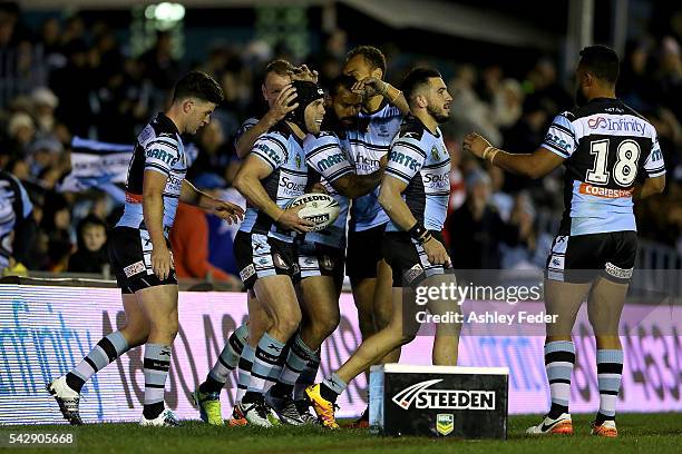 Michael Ennis of the Sharks celebrates a try with team mates during the round 16 NRL match between the Cronulla Sharks and the New Zealand Warriors...