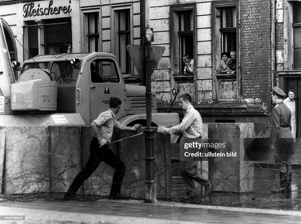 Germany / GDR, Berlin. The building of the wall at Bernauer Strasse. 1961