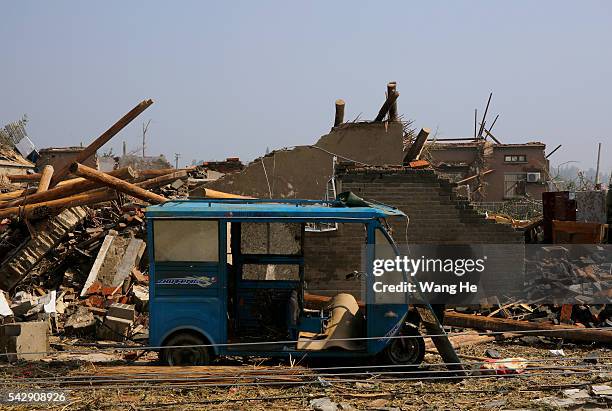 June 25: Motorcycle in front of the damaged houses in Danping Village of Chenliang Township in Funing, Yancheng, east China's Jiangsu Province, June...