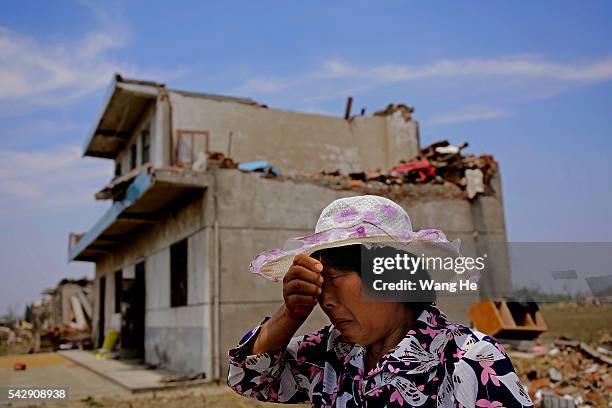 June 25: A villager cries in front of a damaged house in Danping Village of Chenliang Township in Funing, Yancheng, east China's Jiangsu Province,...