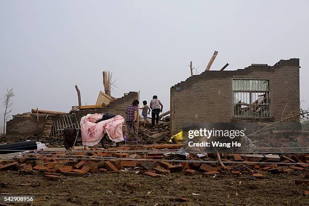 June 25: Villager searches for undamaged articles at their house in Danping Village of Chenliang Township in Funing, Yancheng, east China's Jiangsu...