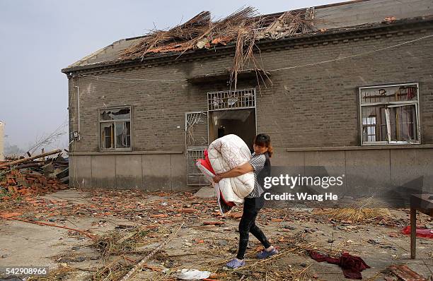 June 25: Villagers holding the quilt to leave the house in Danping Village of Chenliang Township in Funing, Yancheng, east China's Jiangsu Province,...