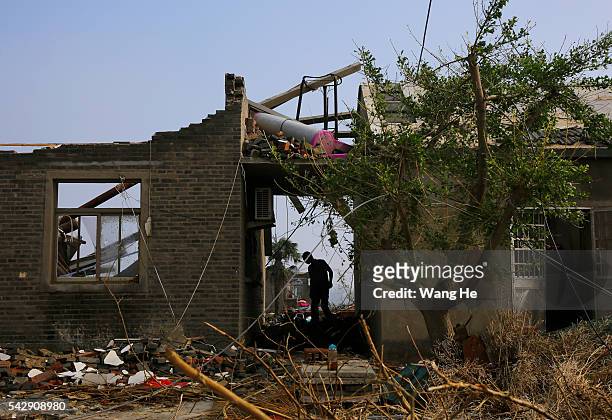 June 25: Villager are seen at their collapsed house in Danping Village of Chenliang Township in Funing, Yancheng, east China's Jiangsu Province, June...