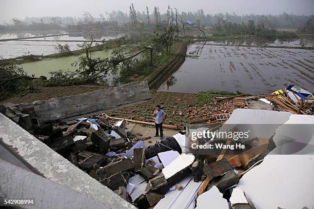 June 25: A villager called up a collapsed house in Danping Village of Chenliang Township in Funing, Yancheng, east China's Jiangsu Province, June 25,...