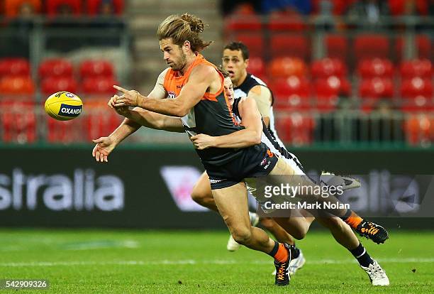 Callan Ward of the Giants hand balls during the round 14 AFL match between the Greater Western Sydney Giants and the Carlton Blues at Spotless...