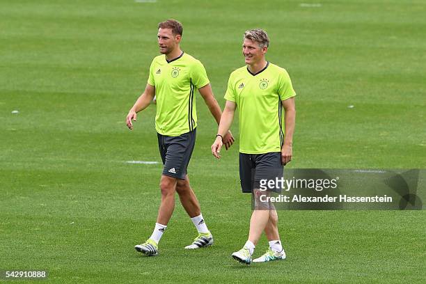 Bastian Schweinsteiger of Germany looks on with his team mate Benedikt Hoewedes during a Germany training session ahead of their Euro 2016 round of...
