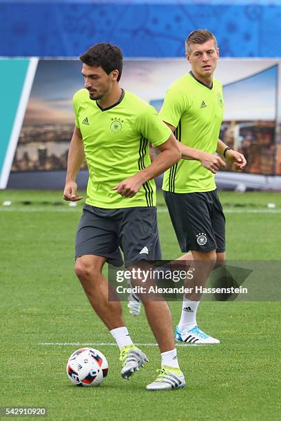 Mats Hummels of Germany plays the ball with his team mate Toni Kroos during a Germany training session ahead of their Euro 2016 round of 16 match...