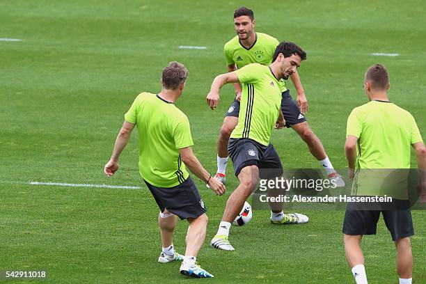 Mats Hummels of Germany plays the ball with his team mates Bastian Schweinsteiger , Jonas Hector and Joshua Kimmich during a Germany training session...