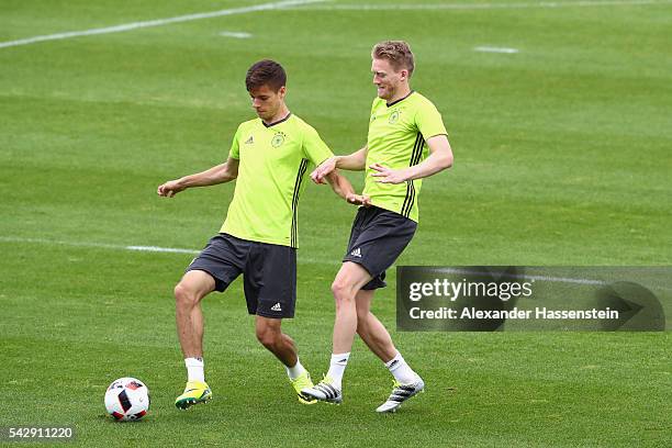 Julian Weigl of Germany plays the ball with his team mate Andre Schuerrle during a Germany training session ahead of their Euro 2016 round of 16...