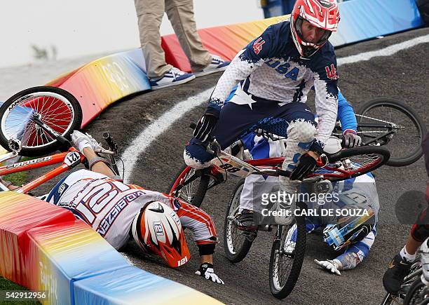 Raymon van der Biezen of the Netherlands crashes causing US cyclist Kyle Bennett to crash and dislocate his left shoulder during the men's BMX...